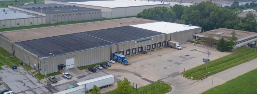 Aerial photo of the Gratton dock doors, roof and parking in Omaha under a clear blue sky
